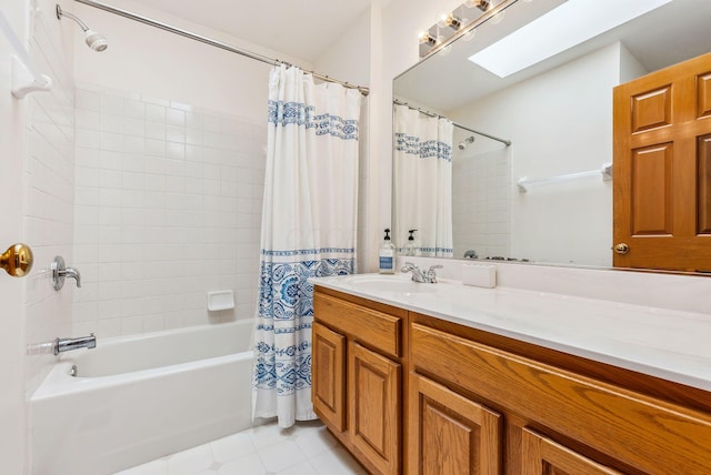 bathroom with tile patterned flooring, vanity, a skylight, and shower / tub combo