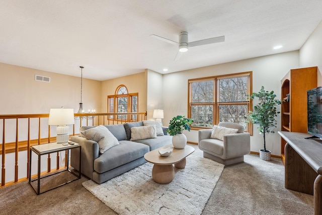 carpeted living room featuring ceiling fan