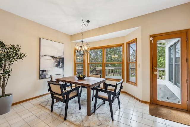 dining area with light tile patterned flooring and a notable chandelier