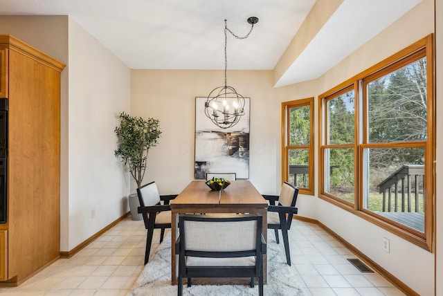 dining space featuring light tile patterned floors and a chandelier