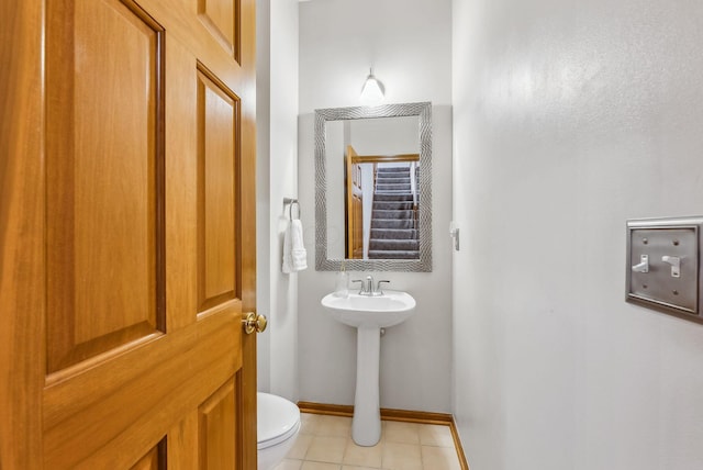 bathroom with tile patterned floors and toilet