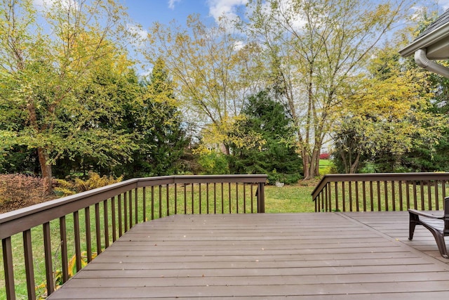 wooden deck featuring a yard