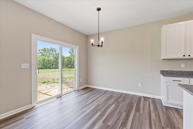 1233 Heathgate Way, Fairborn, OH 45324 - unfurnished dining area featuring a chandelier and wood finished floors