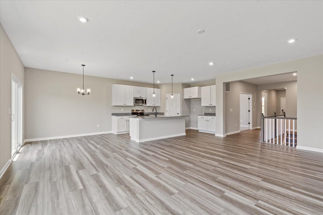 1233 Heathgate Way, Fairborn, OH 45324 - unfurnished living room with light wood-style floors, a chandelier, and recessed lighting