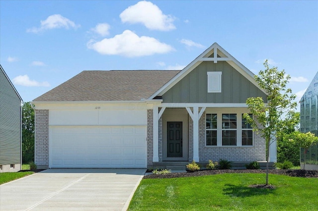1233 Heathgate Way, Fairborn, OH 45324 - view of front of home with board and batten siding, a front lawn, driveway, brick siding, and an attached garage