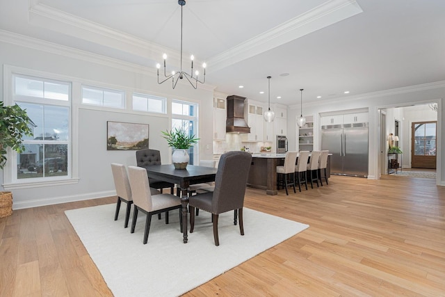 dining area with crown molding, plenty of natural light, and light wood-type flooring