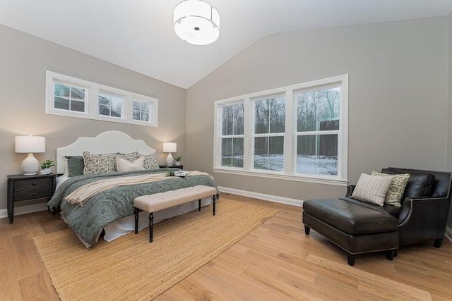 bedroom with vaulted ceiling and light hardwood / wood-style floors