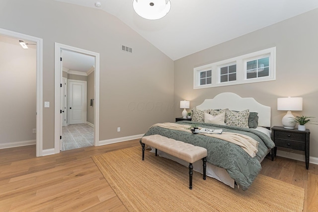 bedroom with vaulted ceiling and light wood-type flooring