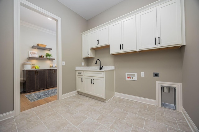 clothes washing area with sink, cabinets, washer hookup, light tile patterned floors, and electric dryer hookup