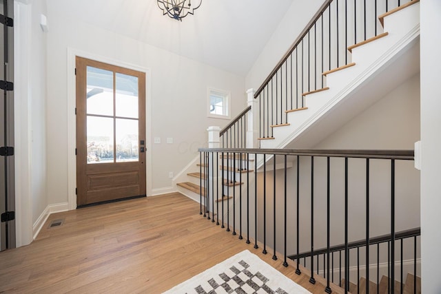 foyer entrance with light hardwood / wood-style flooring and a healthy amount of sunlight