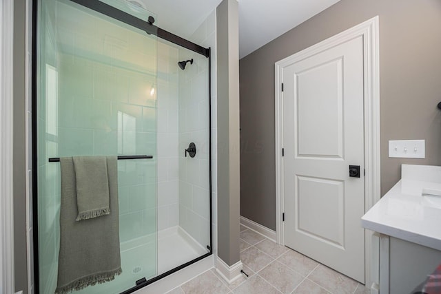 bathroom featuring an enclosed shower, vanity, and tile patterned floors