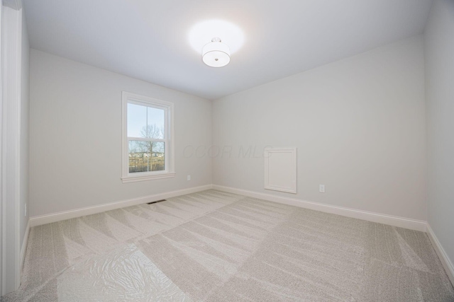 unfurnished room with light colored carpet