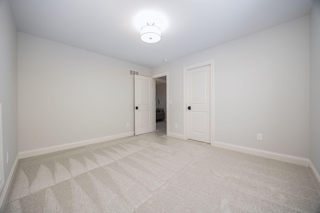 spare room with light colored carpet