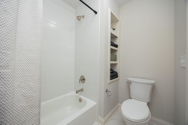 bathroom featuring tiled shower / bath combo and toilet