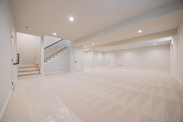 basement featuring light colored carpet