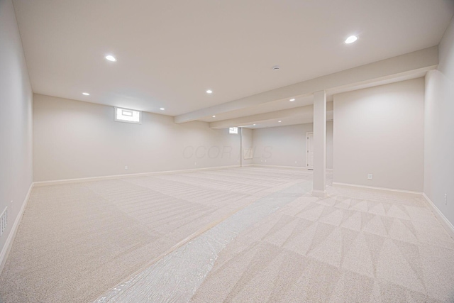 basement featuring light colored carpet