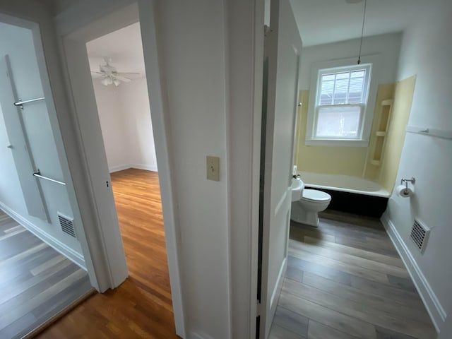 hallway with hardwood / wood-style flooring