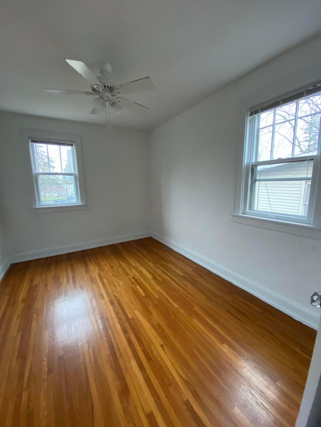 unfurnished room with hardwood / wood-style floors and ceiling fan