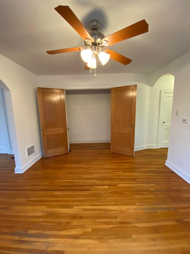 interior space with wood-type flooring and ceiling fan