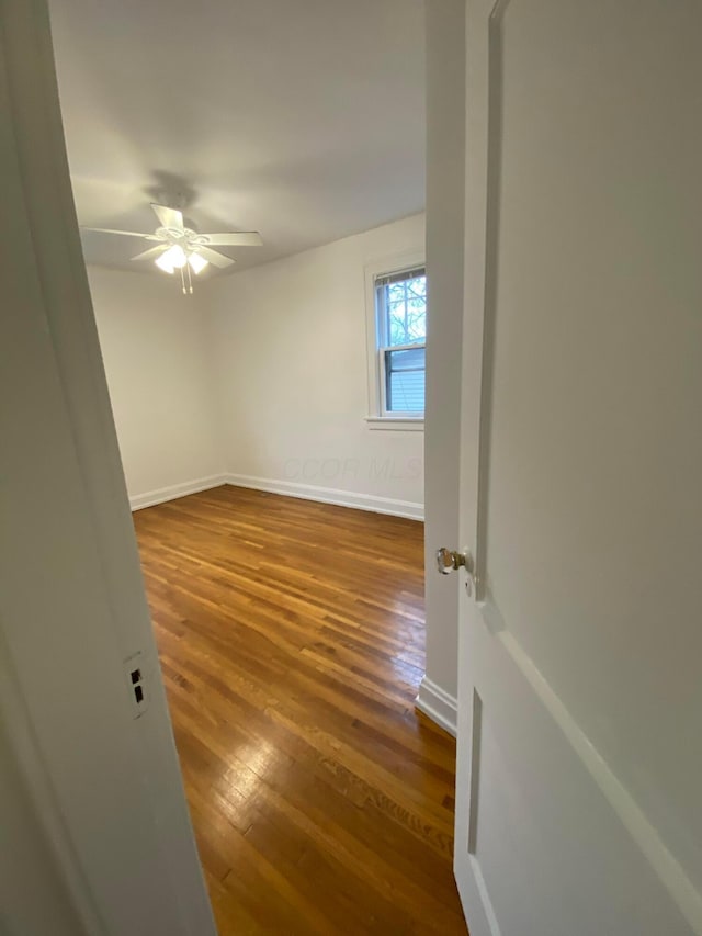 spare room featuring hardwood / wood-style flooring and ceiling fan