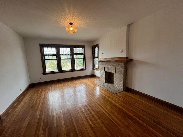 unfurnished living room featuring hardwood / wood-style flooring and a fireplace