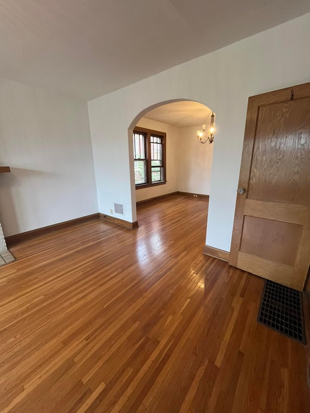 spare room featuring wood-type flooring