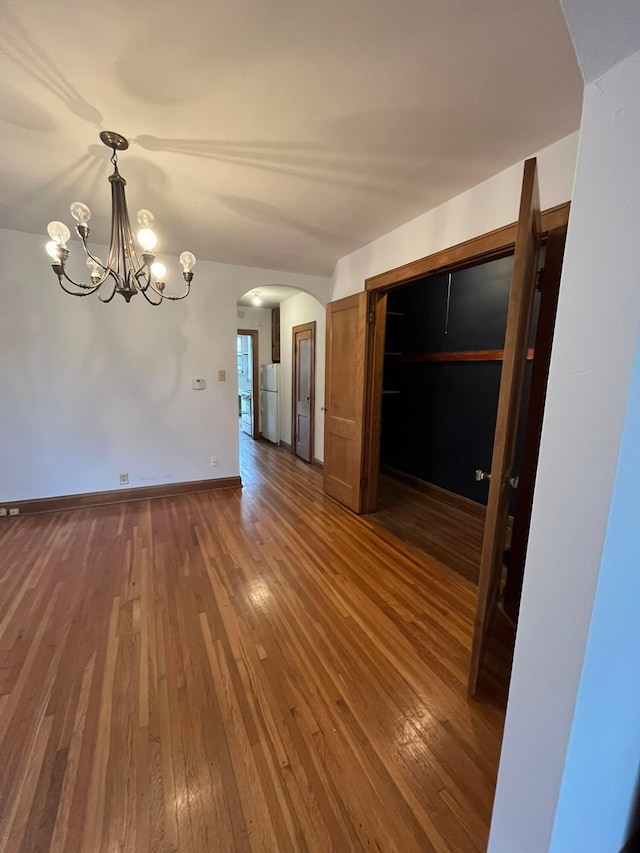 interior space featuring wood-type flooring and a chandelier