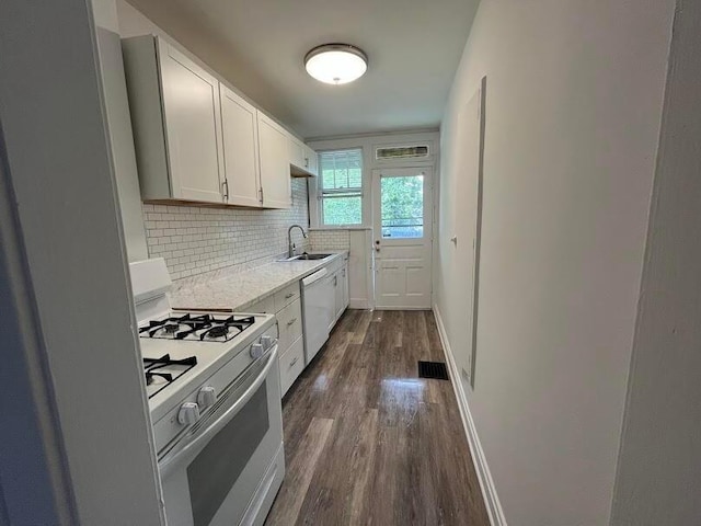 kitchen featuring dark hardwood / wood-style floors, white cabinetry, sink, backsplash, and white appliances