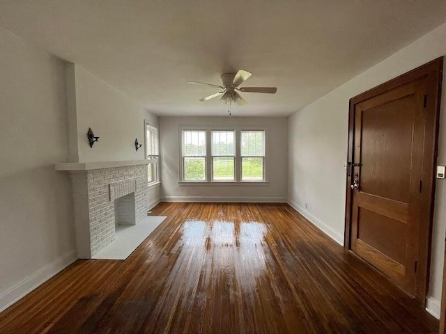 unfurnished living room with wood-type flooring, a fireplace, and ceiling fan