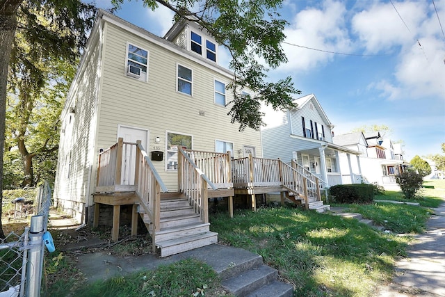 rear view of house with a wooden deck