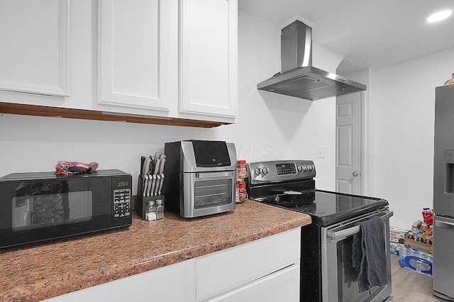 kitchen with island range hood, white cabinets, appliances with stainless steel finishes, and light wood-style floors