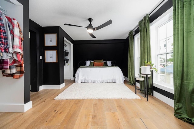 bedroom with ceiling fan and light hardwood / wood-style flooring