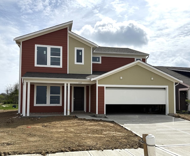 traditional-style home featuring driveway and an attached garage