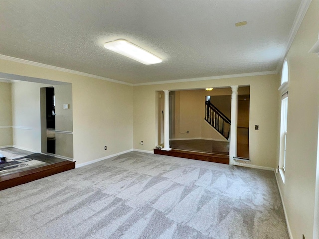 empty room with a textured ceiling, carpet floors, baseboards, stairs, and crown molding