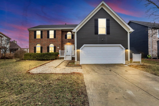 view of front of home featuring driveway and brick siding