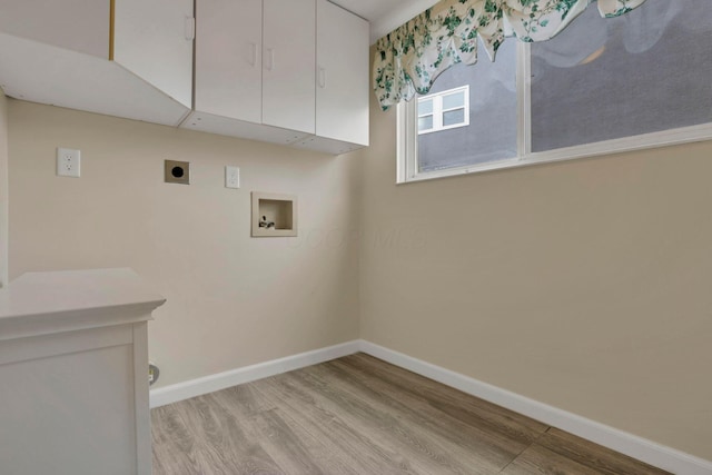 laundry room with hookup for a washing machine, cabinet space, electric dryer hookup, and baseboards