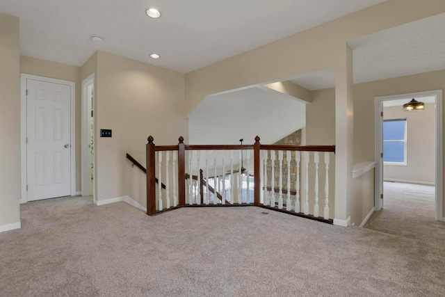 hallway featuring carpet floors, recessed lighting, an upstairs landing, and baseboards