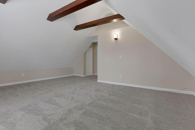 additional living space with vaulted ceiling with beams, carpet flooring, and baseboards