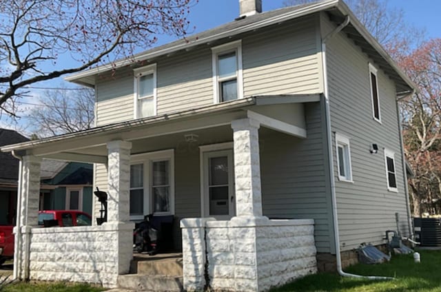 view of front of house with central AC unit and a porch