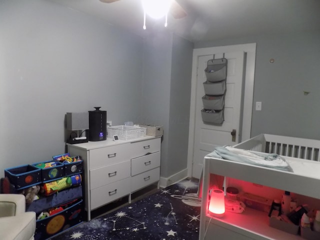 bedroom with ceiling fan and dark carpet