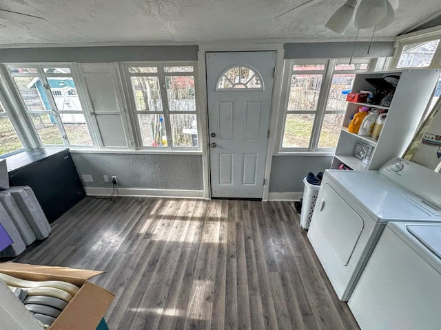 laundry room featuring ceiling fan, dark hardwood / wood-style flooring, washer and clothes dryer, and a textured ceiling