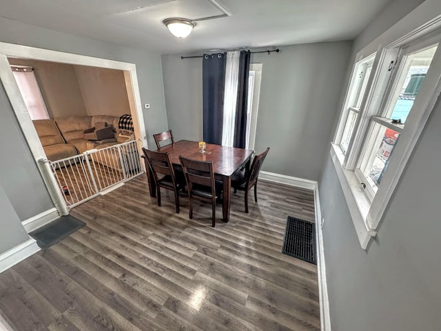 dining area with dark wood-type flooring