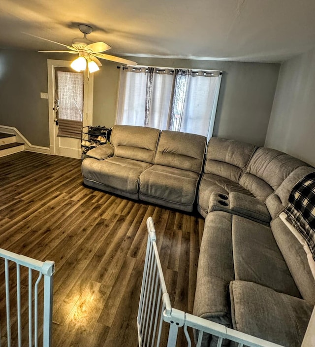 living room with dark hardwood / wood-style floors and ceiling fan