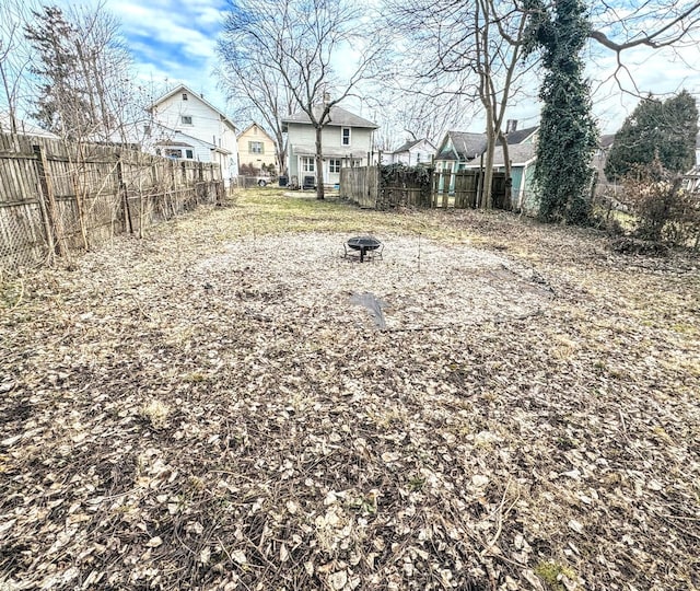 view of yard featuring an outdoor fire pit