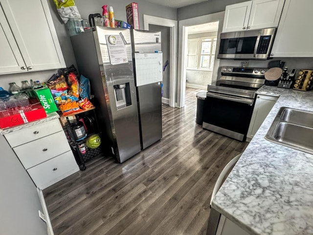 kitchen with white cabinetry, sink, dark hardwood / wood-style flooring, and stainless steel appliances