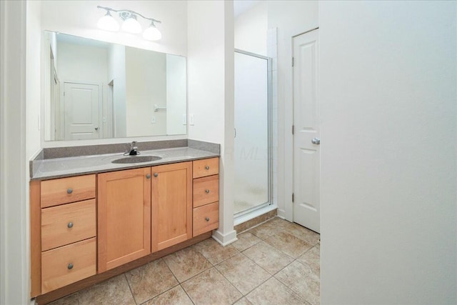 bathroom featuring vanity and a shower with shower door