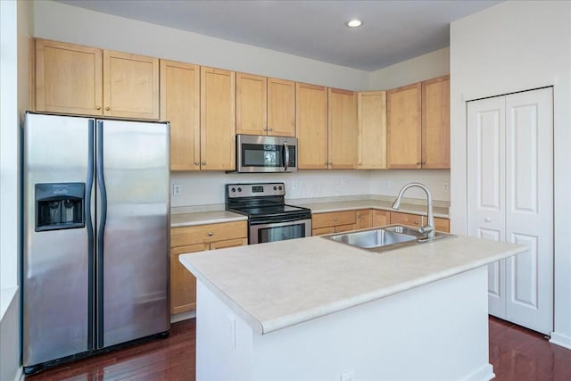 kitchen featuring dark wood-type flooring, sink, light brown cabinets, appliances with stainless steel finishes, and a kitchen island with sink