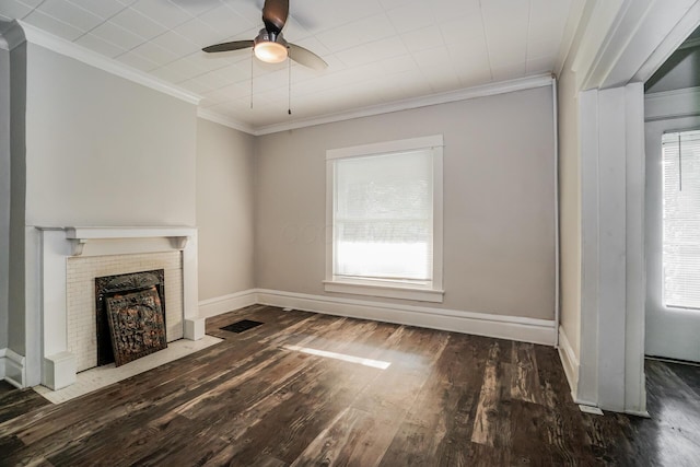 unfurnished living room featuring ornamental molding, dark hardwood / wood-style floors, ceiling fan, and a fireplace