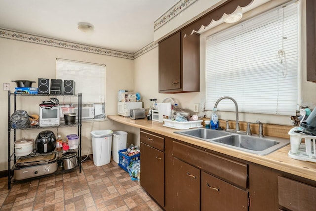 kitchen featuring sink and dark brown cabinets