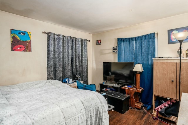 bedroom with dark hardwood / wood-style floors